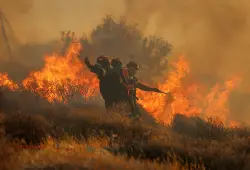 Firefighters race to contain wildfires in Greece as thousands evacuated